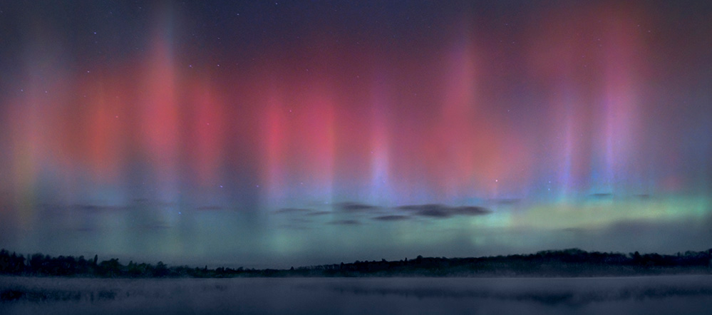 Pink, blue, and green aurora borealis over the BWCA