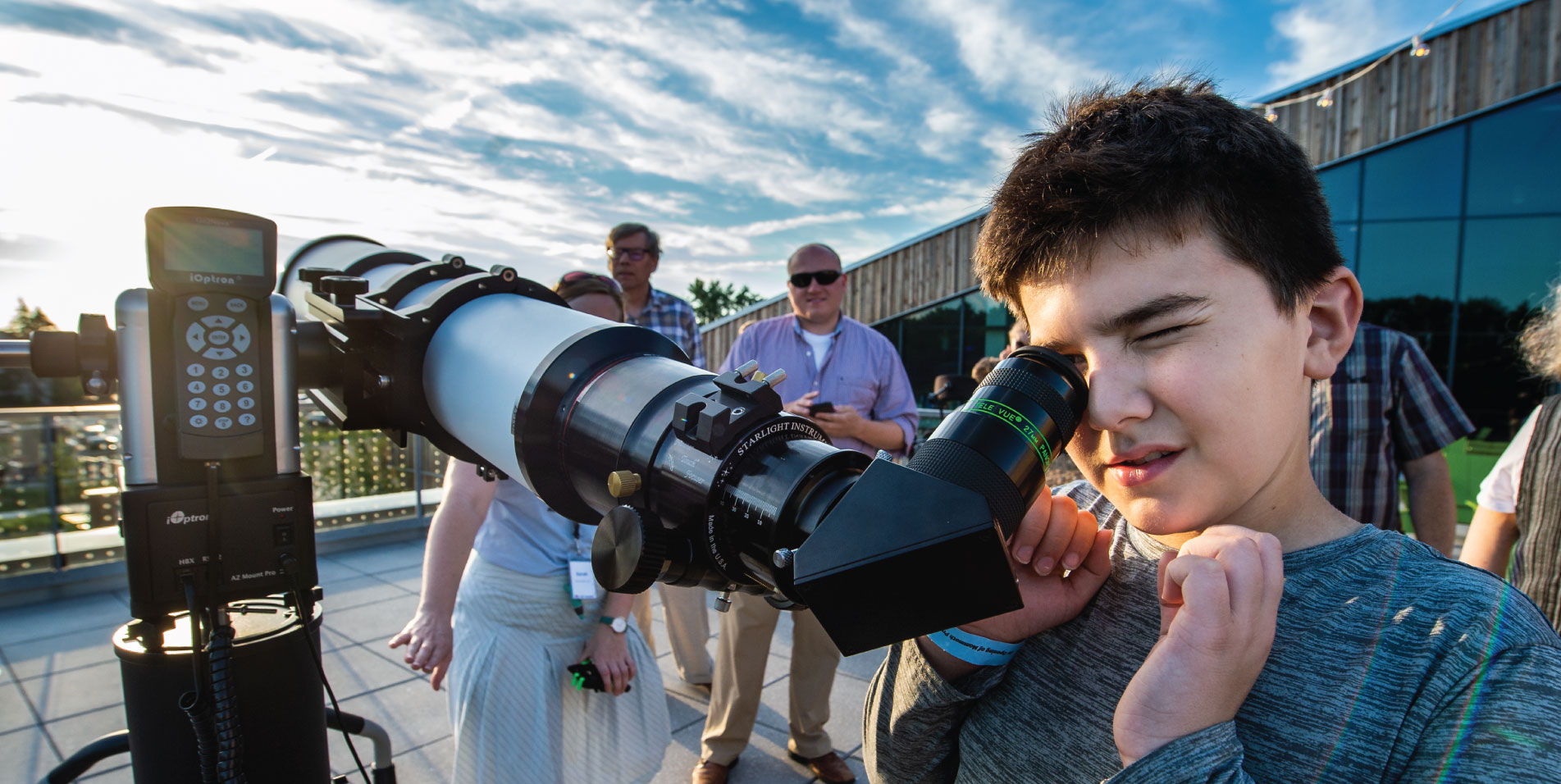 Boy using solar telescope to look at the Sun
