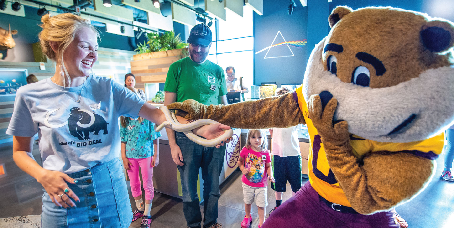 Goldy Gopher visiting the student staff (and snakes) in the Touch & See Lab.