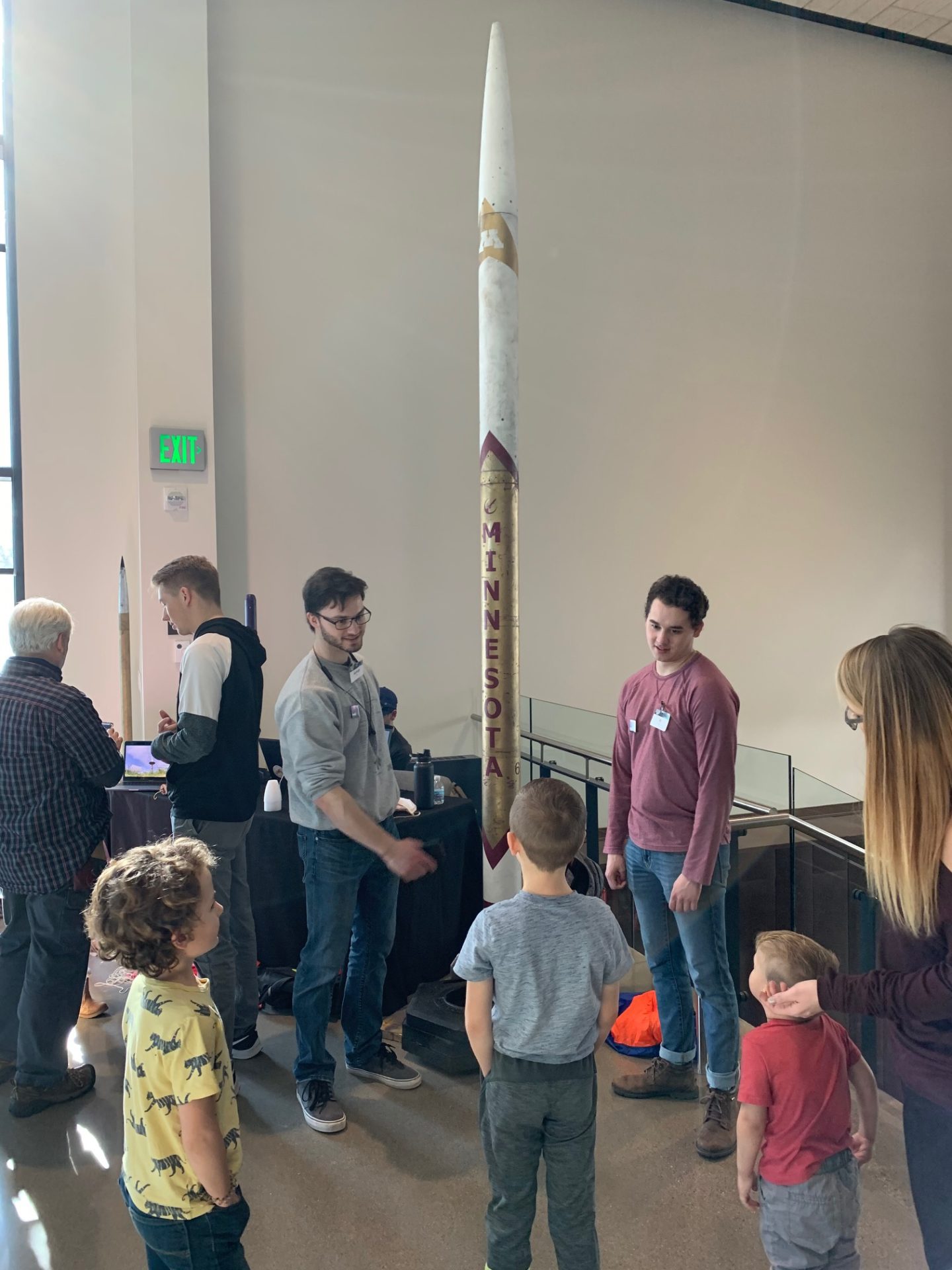 U of M students show a rocket to visitors