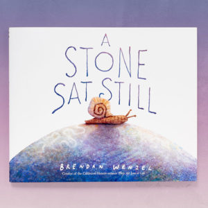 Cover of the picture book, "A Stone Sat Still" -- a snail on a rock