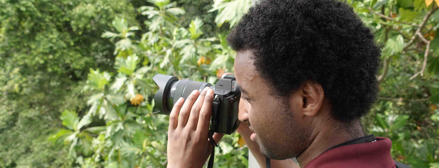 A researcher looks through binoculars