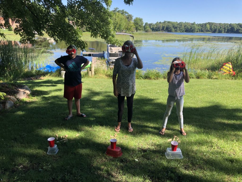 a family looks through goggles in a relay game