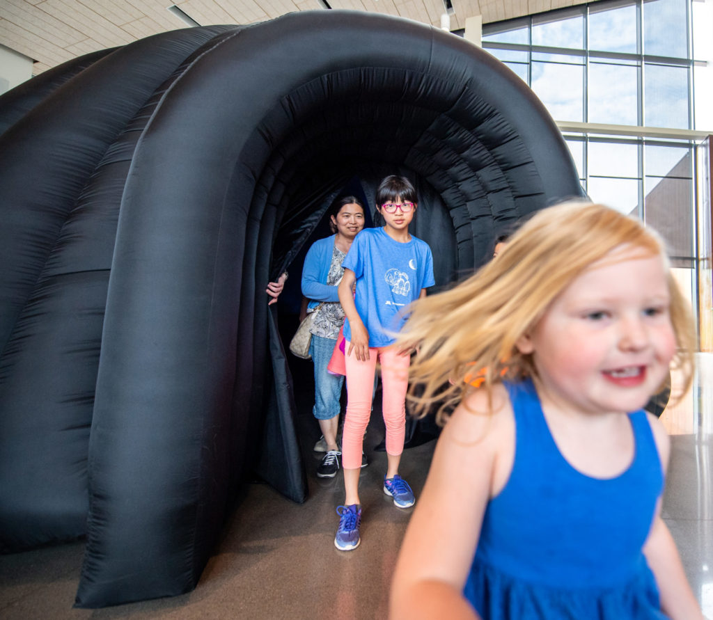 kids walking out of the bell museum's exploradome