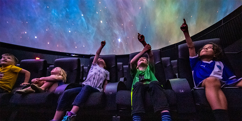 Visitors enjoy a planetarium show