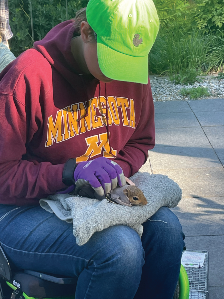 A researcher handling a squirrel