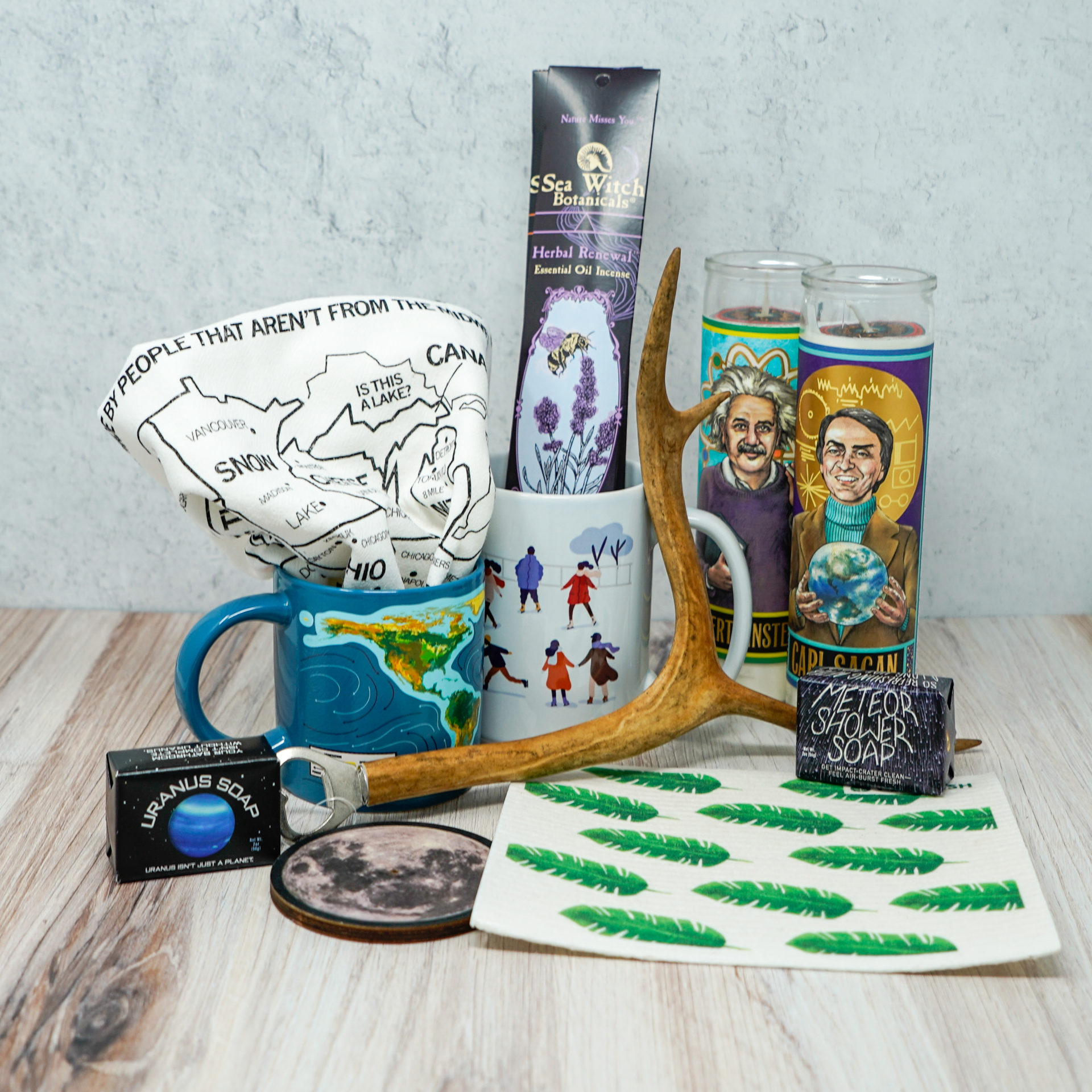 An assortment of home related gifts such as candles, mugs, and rags