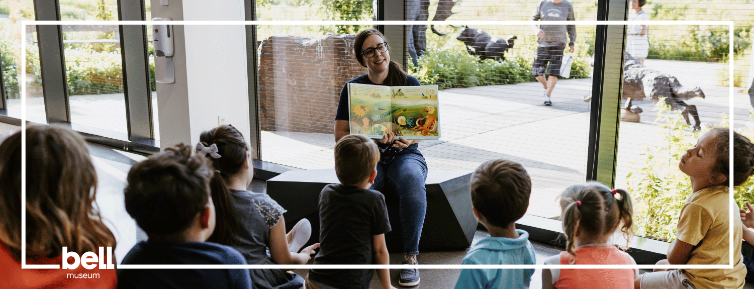 Bell Museum staff member reading to group of children.